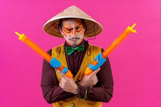 Clown with white facial makeup on a pink background