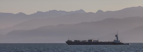 A cargo ship passes the Spit near Homer