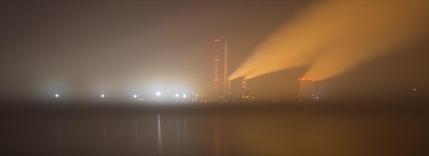 Night over the lagoon with a view of the power plant immersed in fog. Rybnik Poland