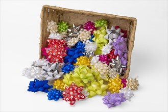 Colourful gift bows falling from a basket