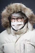 Older man with mask and winter outfit