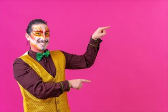 Clown with white facial makeup showing an empty space from the pink background