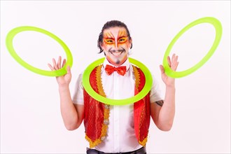 Portrait of a juggler smiling with juggling hoops isolated on white background