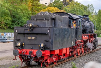 Historical steam locomotive on railway track