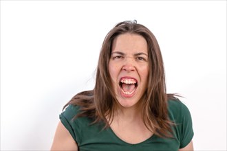 Close-up of a furious woman looking at the camera with her teeth showing on a white background