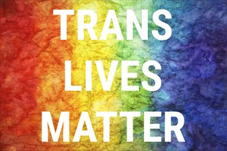 Trans lives matter words on LGBT textured background