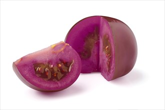 Antioxidant purple tomato quarter section cut isolated on white background