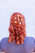 Rear head view of a red-haired woman