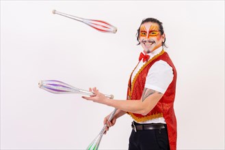 Portrait of a smiling juggler performing juggling isolated on white background