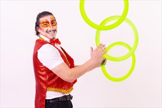 Smiling juggler juggling hoops isolated on white background