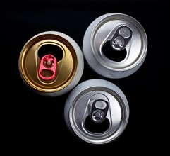 Three opened beer cans