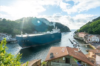 Entrance of a giant ship in the bay of Pasaia to the open sea Pasajes