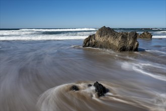 Waves lap stones