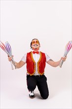 Portrait of a smiling juggler juggling isolated on white background