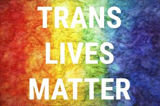 Trans lives matter words on LGBT textured background