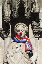 Saint Agnes draped with carnival scarf and red cardboard nose