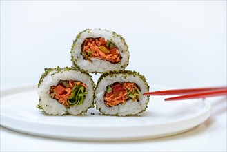 Vegetarian sushi on plates and chopsticks