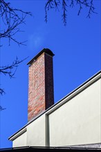 Bricked chimney in front of a deep blue sky