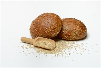 Roll covered with quinoa and scoop with quinoa seeds