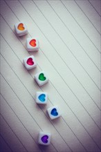 Colorful cubes with a heart placed on paper