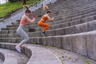 Two young fitness woman in a city park