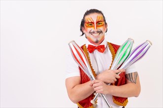 Portrait of a smiling juggler performing juggling with juggling clubs isolated on white background