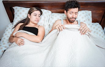 Worried husband with erectile dysfunction in bed