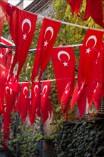 Turkish national flag hang on a pole on a rope in the street in open air