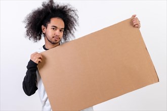 Holding a sign with copy paste space. Young man with afro hair on white background