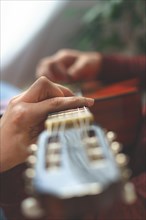 Close-up of a mans hands playing the spanish guitar selective focus