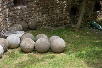 Round stone balls over green grassy background