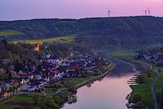 View from the Weserskywalk onto the river Weser with Herstelle Castle at sunset