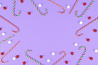 Christmas Candy canes forming frame around purple background with copy space