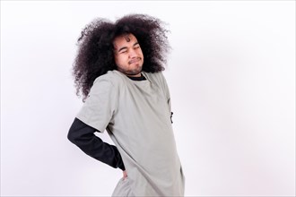 Suffering from back pain. Young man with afro hair on white background