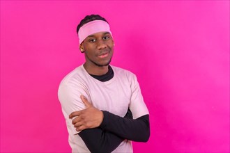 Black ethnic man in pink clothes on a pink background