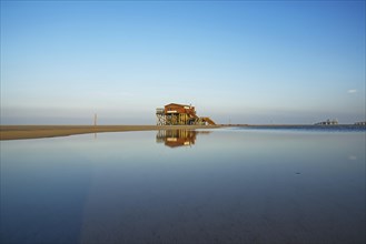 Morning atmosphere on the beach of Sankt Peter-Ording with pile dwellings