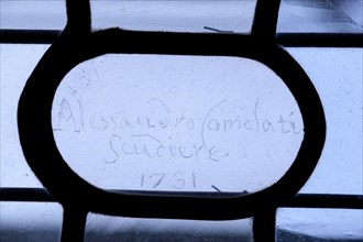 Engraved name of a craftsman 1731 in a window in the Doges Palace