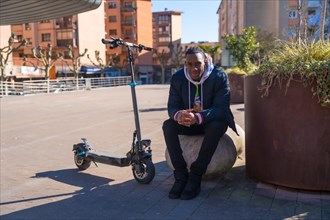 Black ethnic male skateboarding on an electric skate