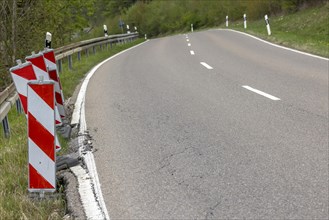 Country road in poor condition with lowered verge