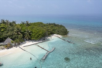 Aerial view: lonely Island with a sandbank and Palmtrees in the Maldives