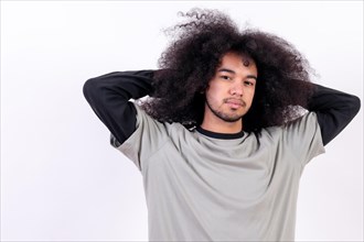 Portrait stretching and waking up. Young man with afro hair on white background