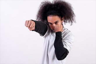 Boxing attack position. Young man with afro hair on white background
