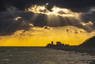 Dramatic sky with sunbeams over lighthouse Strukkamphuk