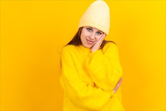 Thinking woman with many ideas with copyspace on yellow background