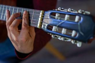 Close-up of a mans hands playing the spanish guitar selective focus