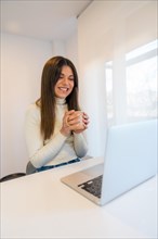 Businesswoman working on a computer with a hot coffee