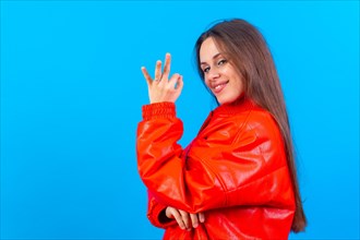 Beautiful woman in casual clothes smiling positively doing ok sign with hand and fingers. successful expression