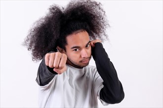 Boxing attack position. Young man with afro hair on white background