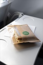 Vegetarian sandwich on a fold-out table on a plane