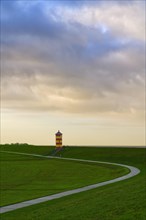 Pilsum lighthouse on the dyke near Greetsiel in the Krummhoern region on the East Frisian North Sea coast
